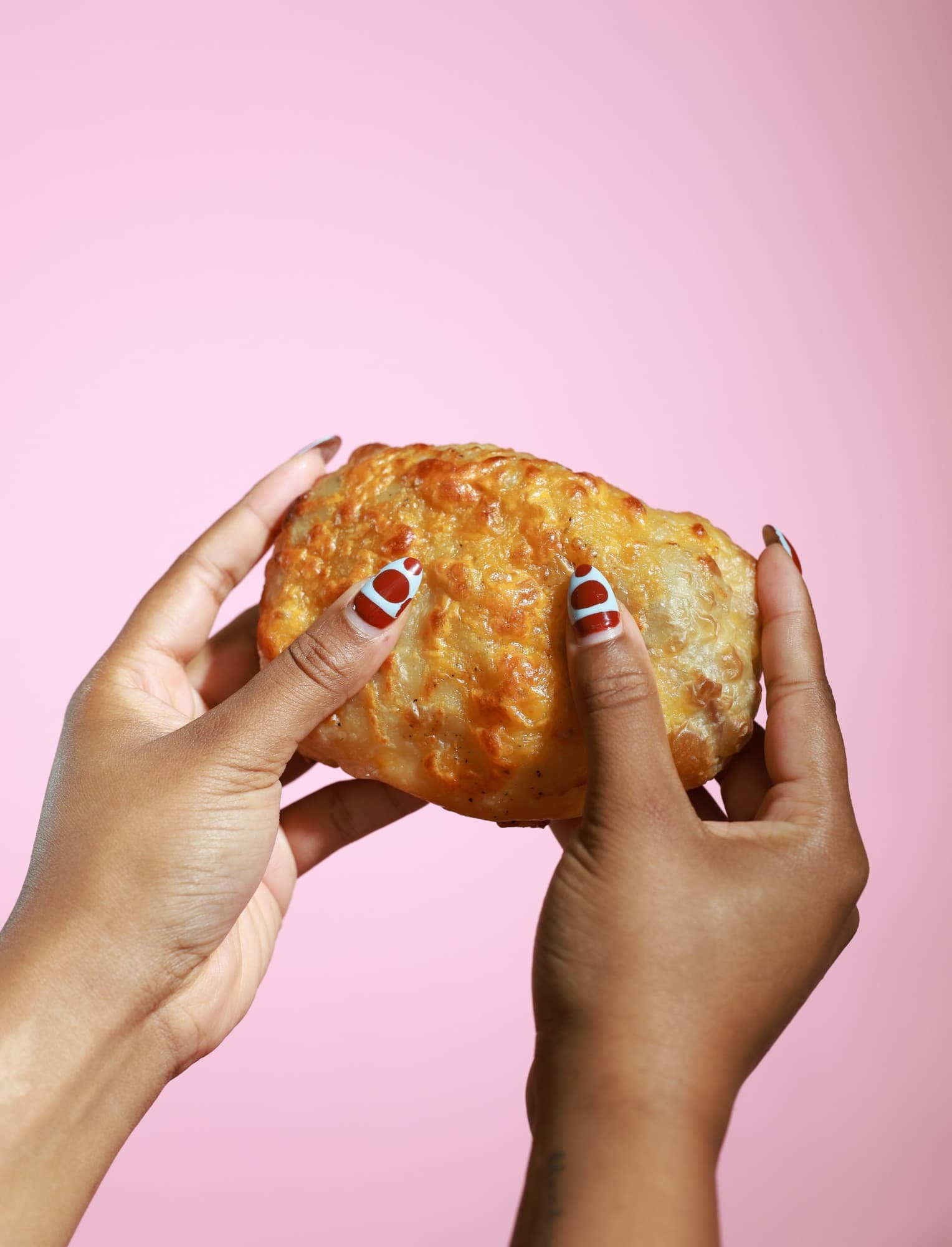 Hands holding a ThoroughFare kolache